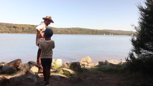 Man Hat Ginger Beard His Son Look Out Lake Boats — Vídeo de stock