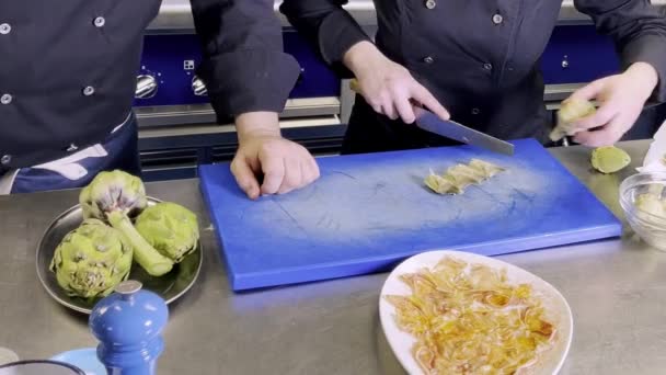 Chef Surveilling Other Chef While Preparing Artichokes — Stock Video