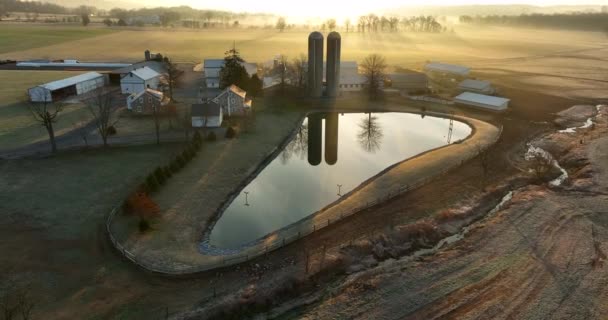 Establishing Shot Farm Silo Reflections Pond Water Winter Sunrise Aerial — стоковое видео
