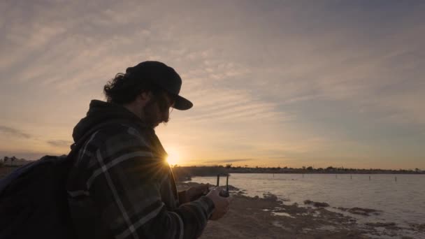 Man Controlling Drone Remote Controller Sunset Pink Lake Torrevieja Spain — Vídeos de Stock