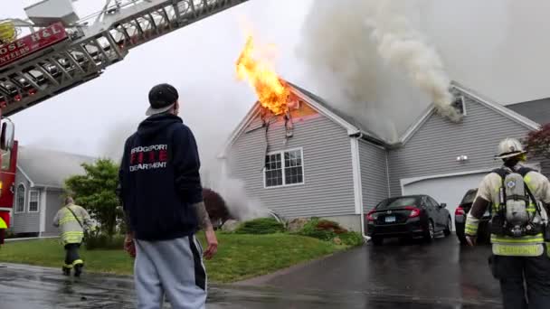 Bystander Watches Flames Shoot Out Roof Burning Home Rain — Vídeo de Stock