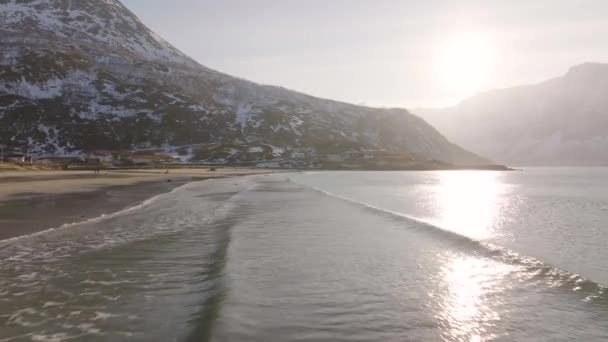 Small Waves Run Sandy Arctic Beach Patchy Snow Mountain Aerial — 비디오