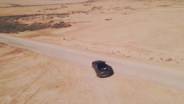Black Touring Car Merging Long Road Vast Orange Desert Aerial — Vídeo de Stock
