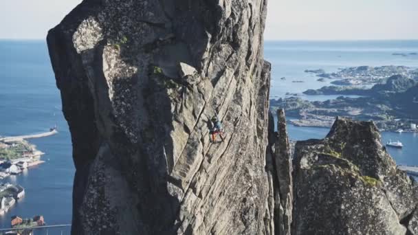 Powerful Person Trad Climbing Rocky Cliff Norway Ocean Handheld View — стокове відео