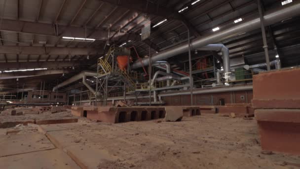 Slider Footage of Machinery and Furnaces in an Abandoned Brick Factory with Dusty Bricks in the Foreground