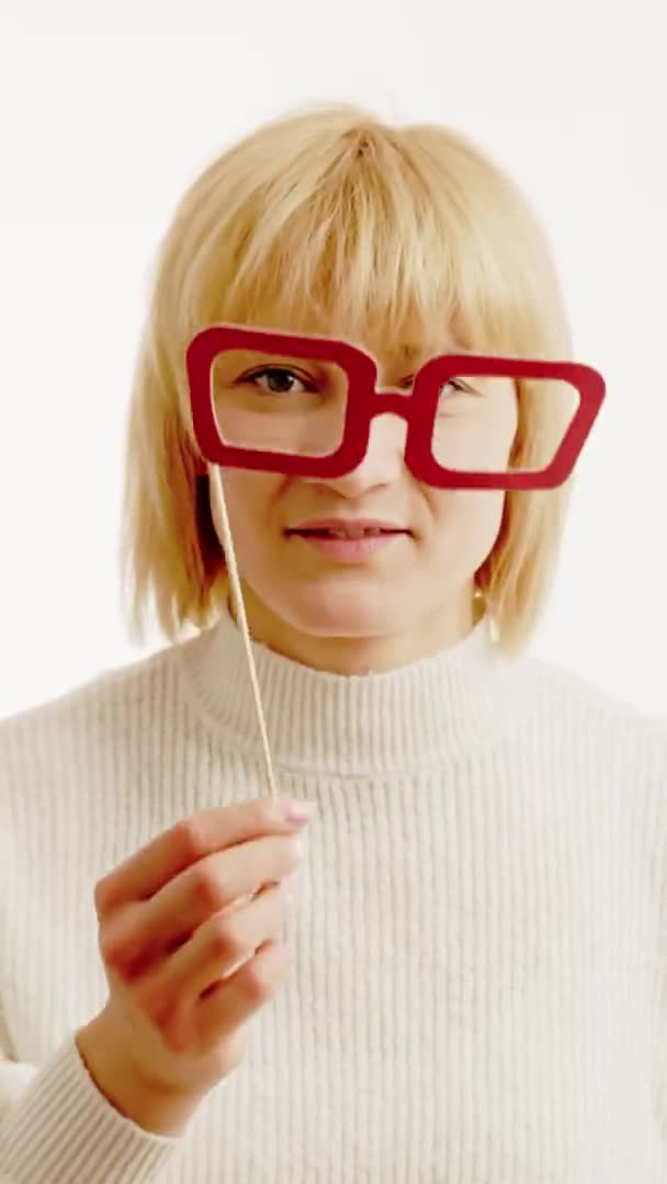 Girl Putting His Face Fake Red Glasses Isolated White Vertical — Vídeo de Stock