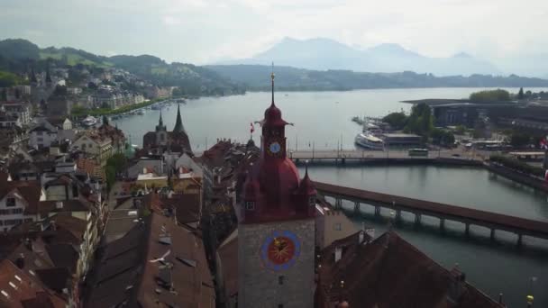 Aerial orbit around town hall clock tower of medieval city Lucerne, Switzerland