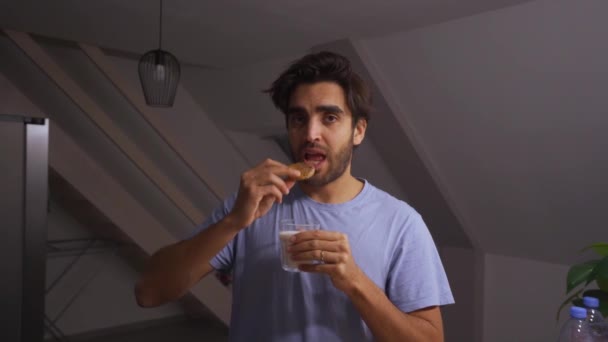 Man Dipping Chocolate Chip Cookie Glass Milk Eating While Making — Video