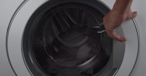 Young Man Adding Laundry Detergent Machine Load Pre Wash — Stok video