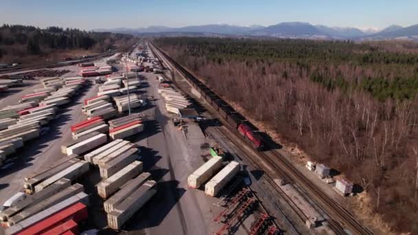 Aerial Tracking Shot Cargo Train Running Railway Vancouver Shipping Terminal — стоковое видео