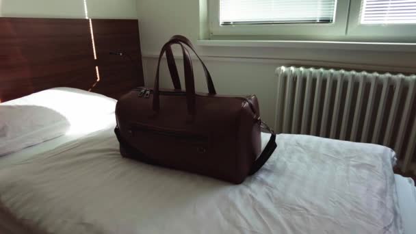 Brown Leather Bag Sits Hotel Single Bed Morning Light Window — 비디오