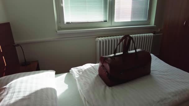 Brown Travel Bag Laid Hotel Room Lit Morning Sun — Vídeo de Stock