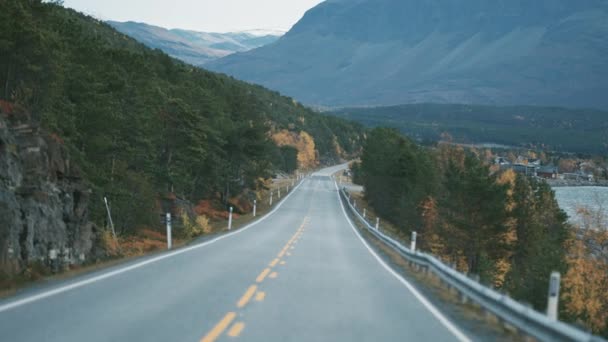 Narrow Two Lane Road Snaking Fjord Snow Capped Mountains Horizon — стоковое видео