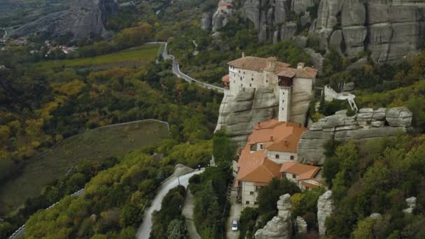 Aerial View Roussanou Monastery Overlooking Winding Roads Foliage Forest Cloudy — Stockvideo