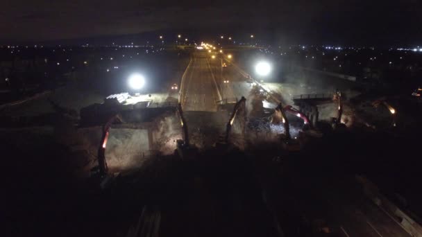 Several Excavators Dig Rubble Highway Night — стоковое видео