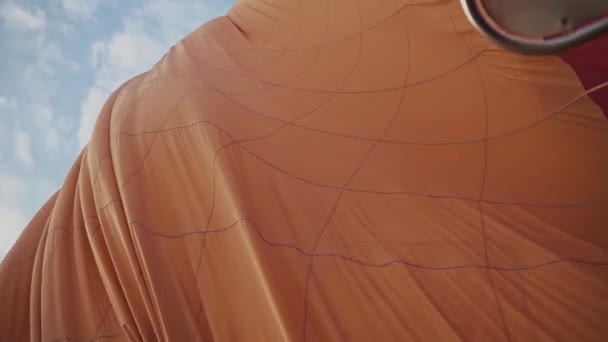 Orange Color Hot Air Balloon Deflating Ground Blue Sky Handheld — Stock video