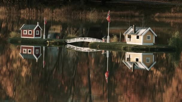 Idyllic Scene Toy Houses Middle Lake Reflected Mirrorlike Still Water — Stockvideo