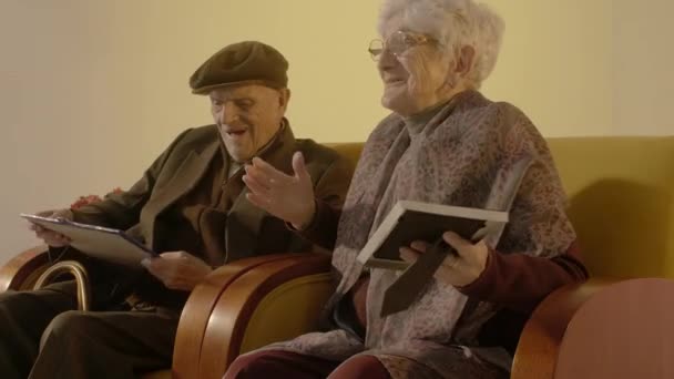 Elder Couple Looking Photos Laughing — Stock Video