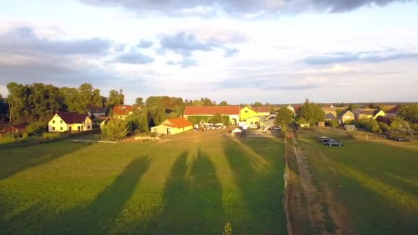 德国勃兰登堡的一个小村庄 在夏日的日落时分 一架无人驾驶飞机从长着长长的树影的农场向前方飞去 菲利普 马尔尼茨的电影自然观 — 图库视频影像