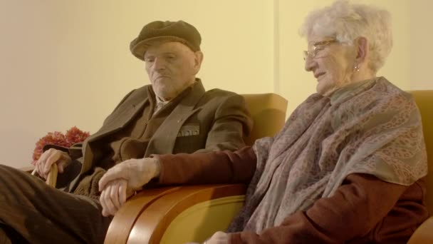 Elder Couple Sitting Couches Holding Hands — Stockvideo