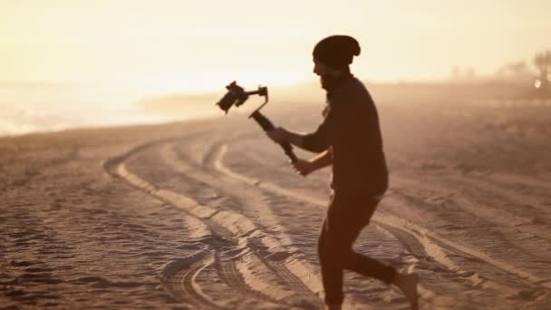Professional Freelancer Video Filmmaker Photographer Walking Gimbal Sandy Beach Golden — Video Stock