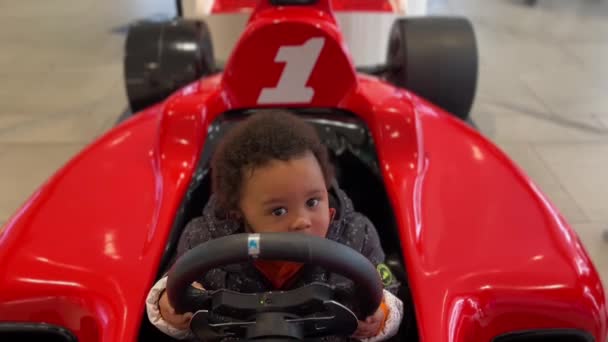 Two Year Old Exotic Afroeuropean Baby Enjoying Toy Red Car — Stockvideo