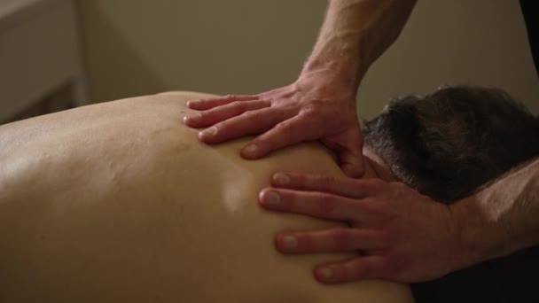 Strong Masseur Hands Kneading Massaging Back Male Patient — Stockvideo
