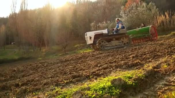 Crawler Tractor Seeder Moving Land Field Sunset Slow Motion Medium — стоковое видео