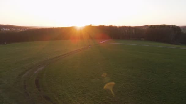 Person Scooter Standing Green Field Magnificent Sunset Germany Aerial Establishing — Video Stock