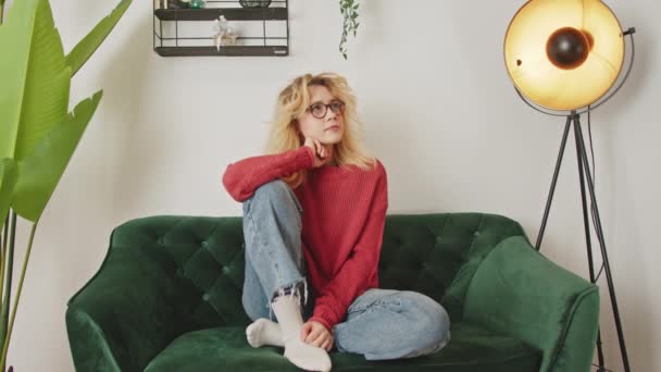 Millennial Caucasian Girl Cozy Casual Clothes Sitting Couch Home Looking — Stockvideo