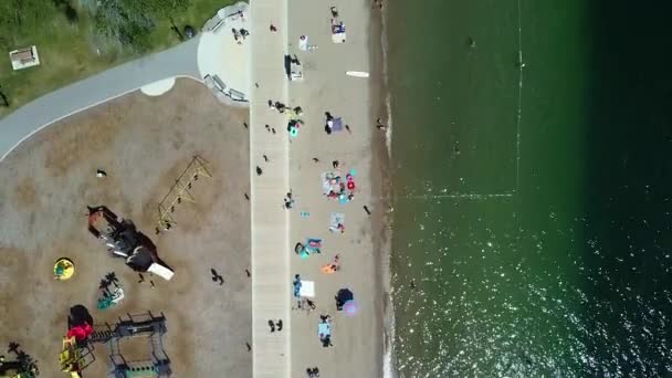 Drone Aerial View Lake Beach Showing Swimmers People Tanning Lounging — Vídeos de Stock