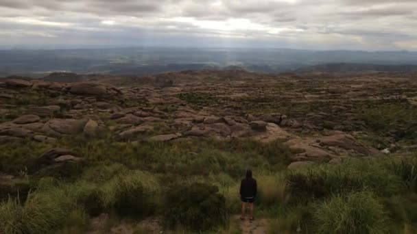 Aerial Orbit Shot Young Man Front Highland Enjoying Panorama View — Vídeos de Stock