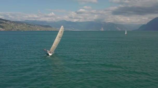 Wide Aerial Man Hanging Overboard Sailboat Order Steady Vessel — Vídeos de Stock