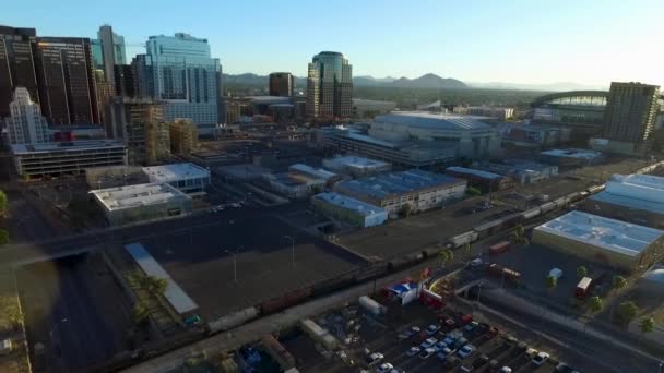 Wide Aerial View Morning Sun Passing Phoenix Arizona Skyline Train — стоковое видео