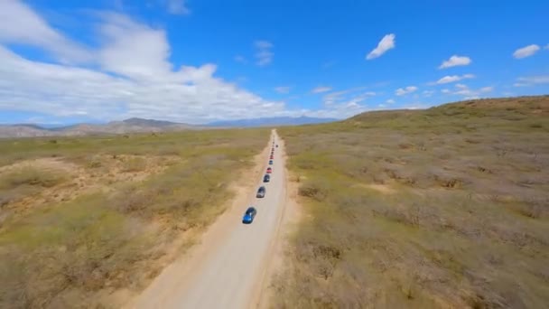 Drone Flying Group Mini Cooper Cars Driving Rural Unpaved Road — стокове відео