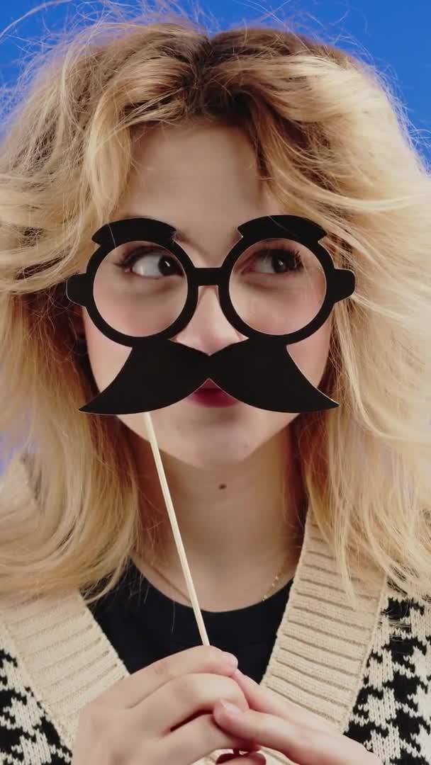 Vertical Video Goofy Young Caucasian Girl Hold Mustache Glasses Stickon — Stock videók