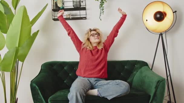Millennial Καυκάσιος Κορίτσι Που Εκτείνεται Σηκώνοντας Χέρια Άνετο Καναπέ Στο — Αρχείο Βίντεο