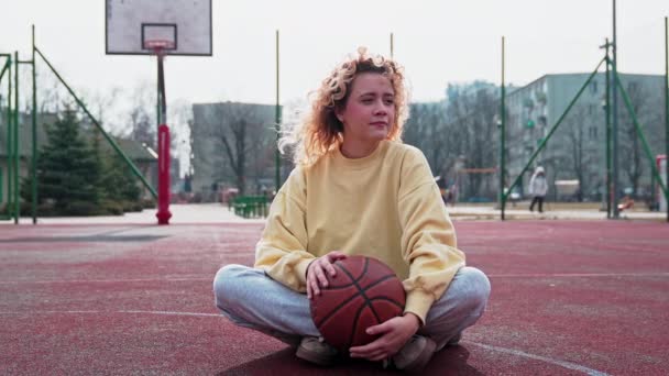 Young Girl Basketball Court Meditating Looking Camera — ストック動画