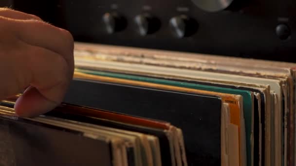 Close up man hands browsing vintage vinyl records at home. Searching music