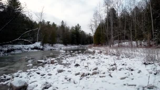 Frozen Rocky River Bank Light Dusting Snow Flowing River Low — Stock Video