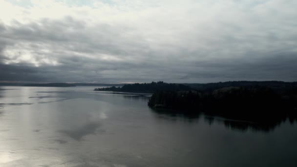 Dark Forested Shoreline Puget Sound Gloomy Skies Silver Reflection Aerial — Stockvideo