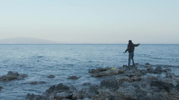 Young Man Fishing Casting Line Sea Wide Shot Coast — Vídeo de Stock