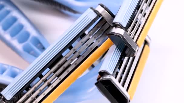 Used Disposable Shaver Razor Blades Rotating White Background Macro Shot — Vídeo de stock