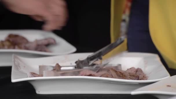在自助餐中 人们在盘子里享用切碎的烤肉 — 图库视频影像