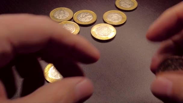 Coin spinning by hand on a wooden table. Abundance prosperity concept