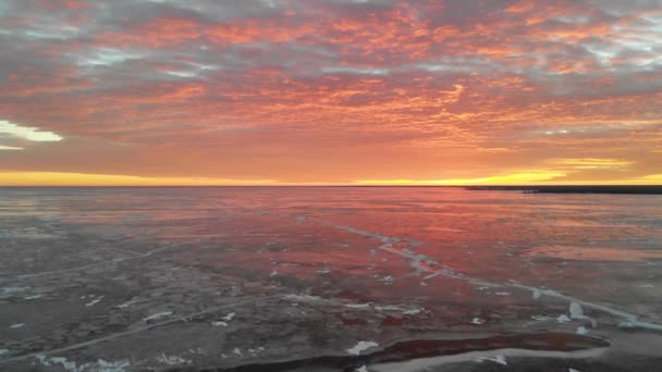 Drone Rising Vertically Large Frozen Lake Looking Bright Red Sunrise — Video
