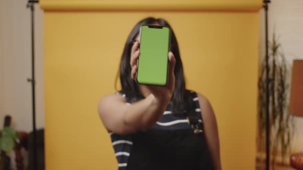 Young Asian Woman Pushes Mobile Phone Camera Showing Green Chroma — Stock video