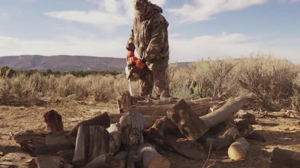 Man Hunting Gear Uses Chainsaw Cut Firewood Camo Gear — Video