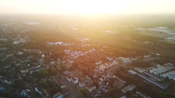 Drone shot of the houses and buildings in Bochum Langendreer in Germany. Landscape aerial drone pan shot on a sunny morning with a foggy background. 4K UHD