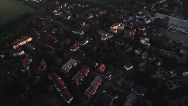 Aerial shot of the houses and buildings in Bochum Langendreer in Germany. Landscape drone zoom shot at dusk with a foggy background. 4K UHD